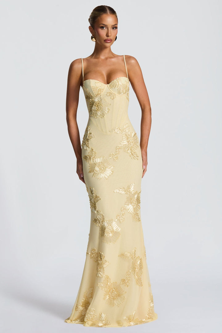 Sleeveless cream maxi dress featuring gold embroidered sunflower details