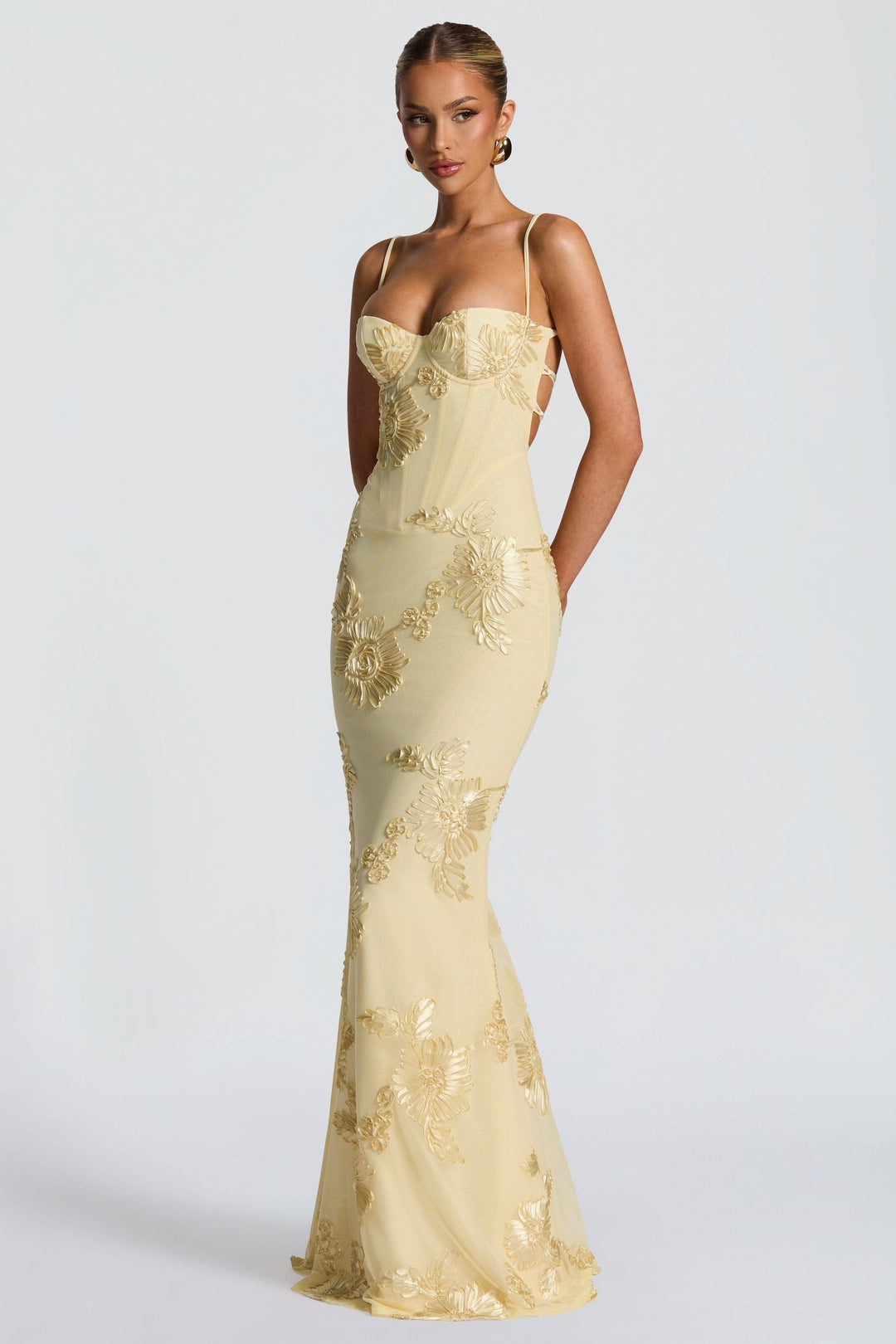Fitted cream maxi dress with spaghetti straps and gold embroidered flowers