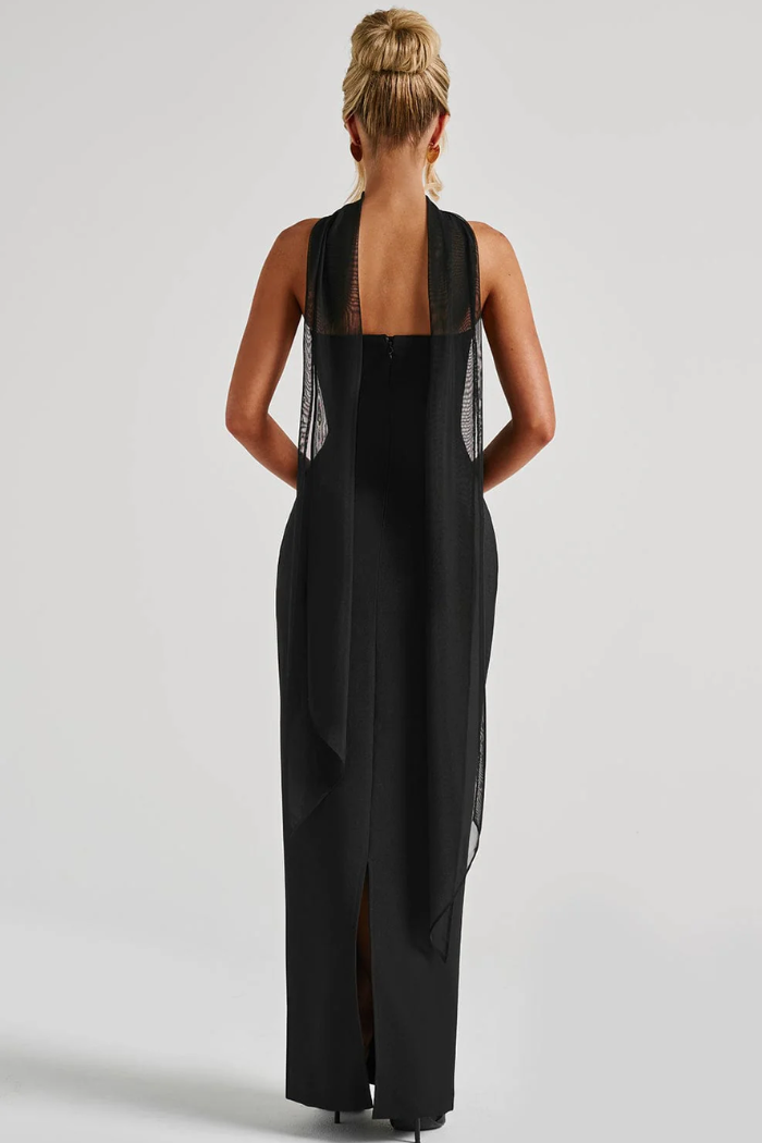 Back view of black strapless maxi dress with sheer overlay and slit detail