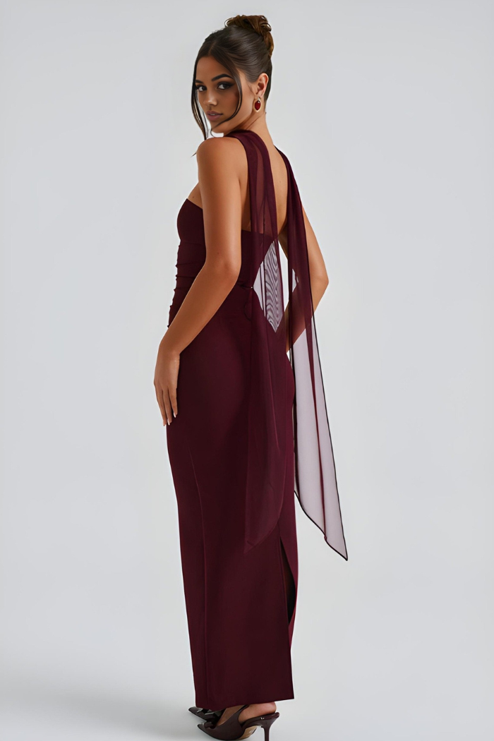 Back view of burgundy strapless maxi dress with sheer overlay and open back detail