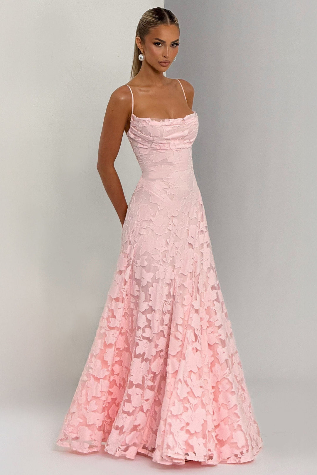 Side profile pink floral maxi dress with flowing skirt and side pockets