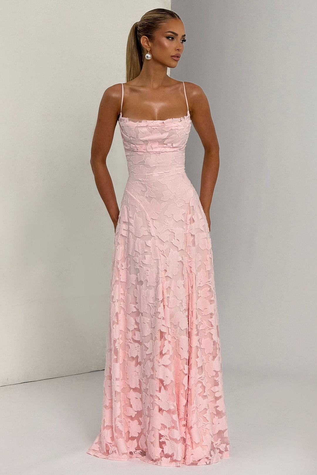 Close-up of pink floral lace texture on cowl neck maxi dress bodice