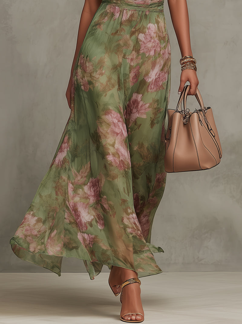 Flowing skirt detail of green floral halter maxi dress with pink roses