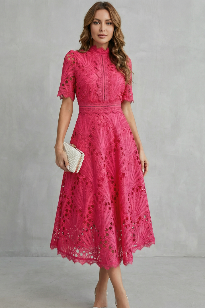Front view of pink wedding guest lace midi dress with high neck and fitted waist