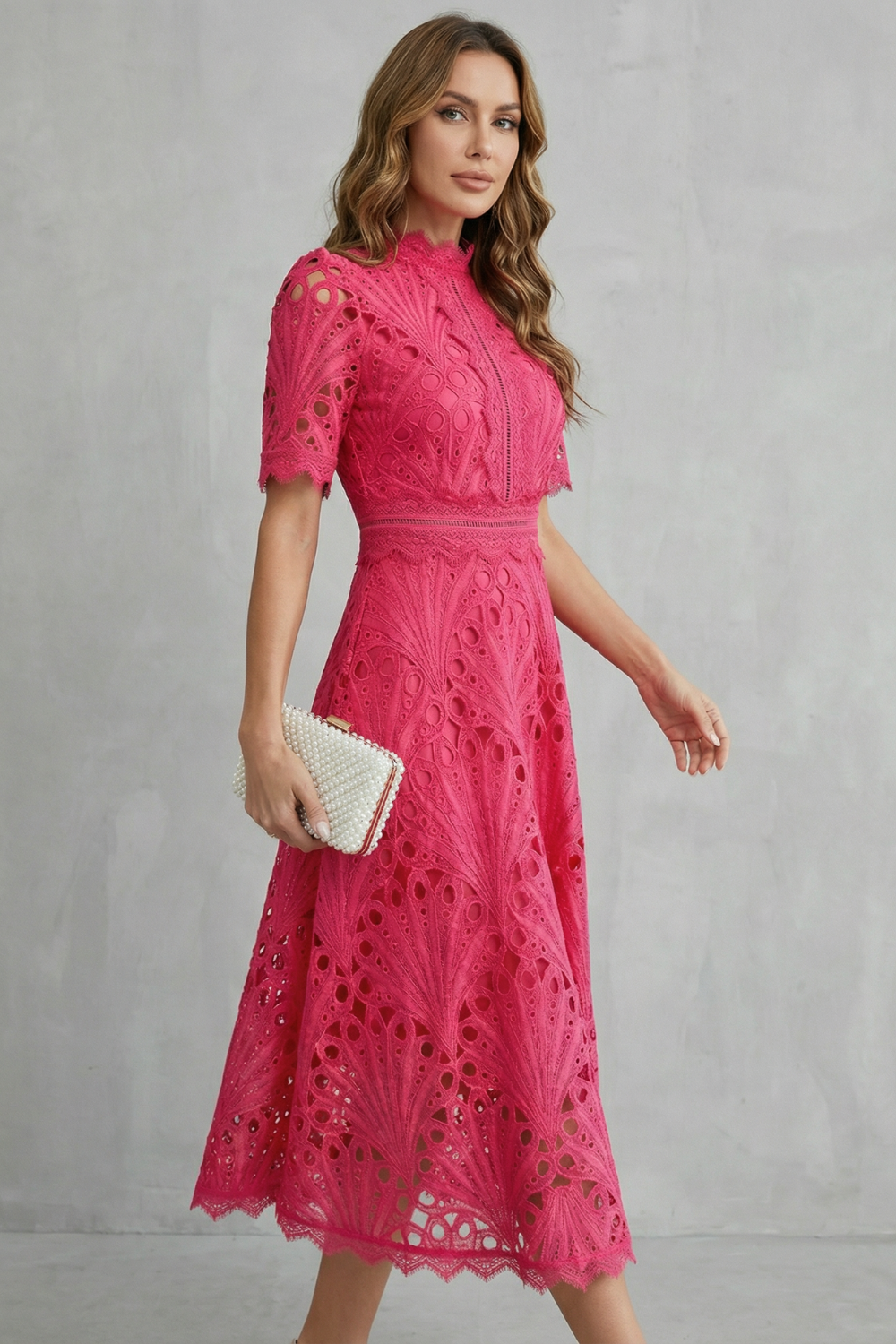 Side angle of pink lace midi dress showing short sleeves, high neck, and flared skirt
