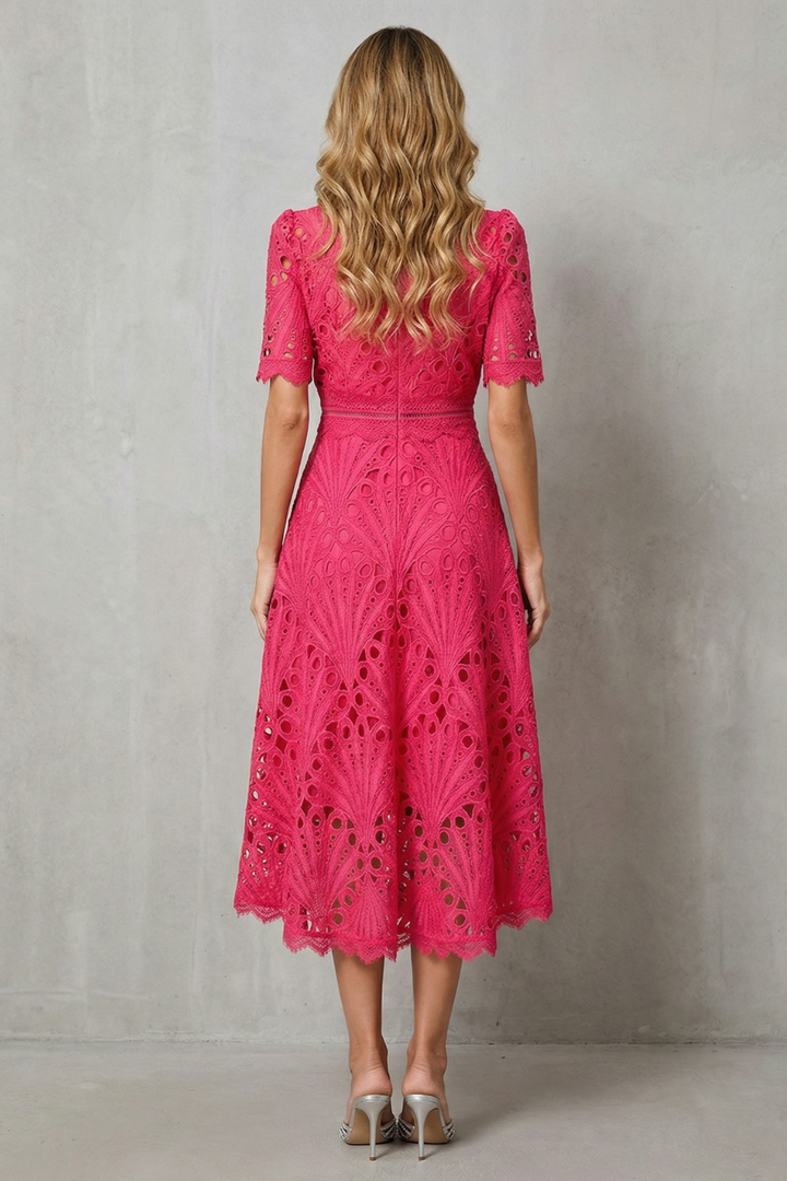 Back view of pink lace wedding guest midi dress with zip closure and scalloped hem