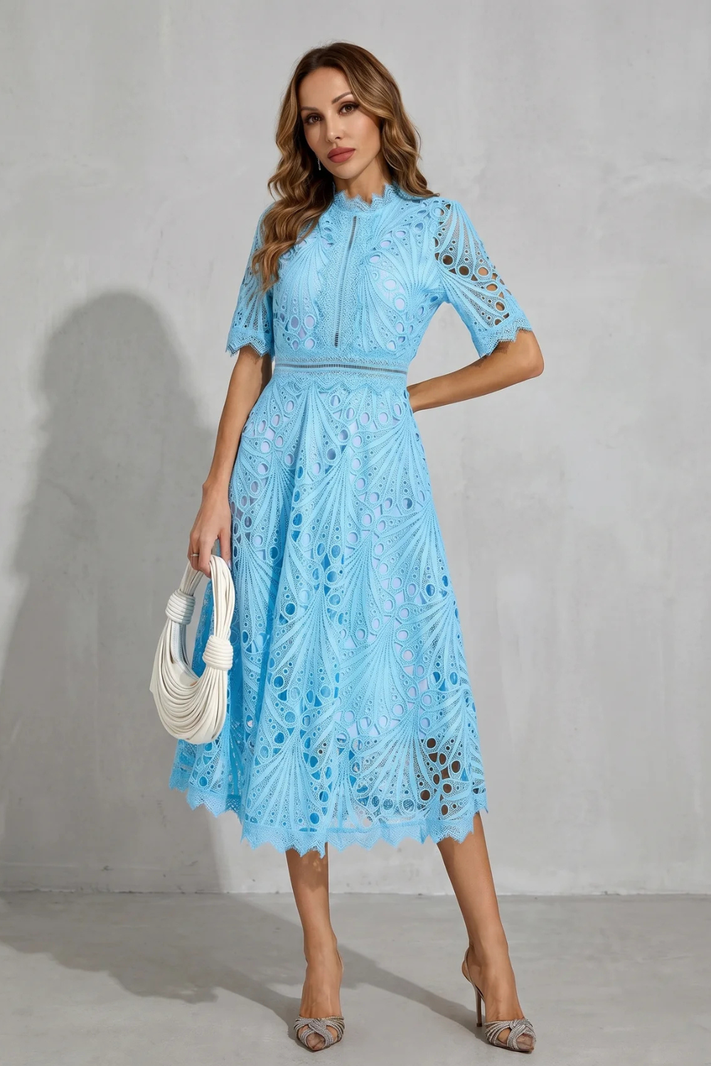 Front view of light blue wedding guest lace midi dress with high neck and sheer cutout details