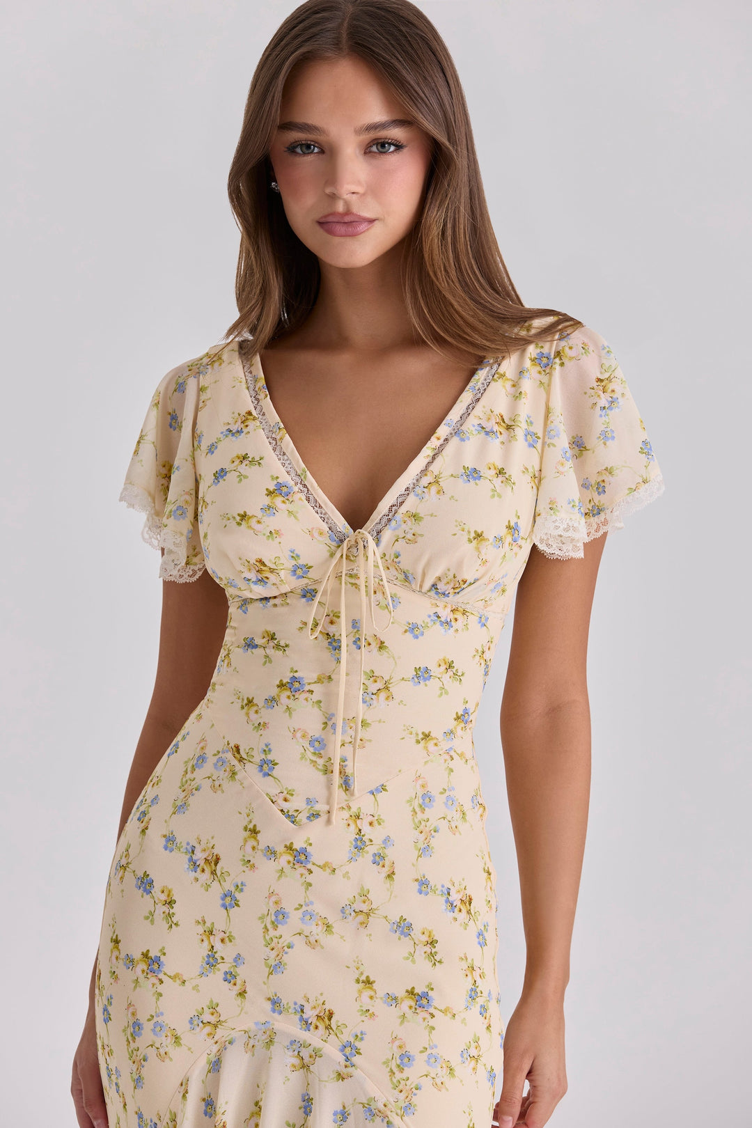 Rear view of a floral summer maxi dress with fitted waist and full-length skirt