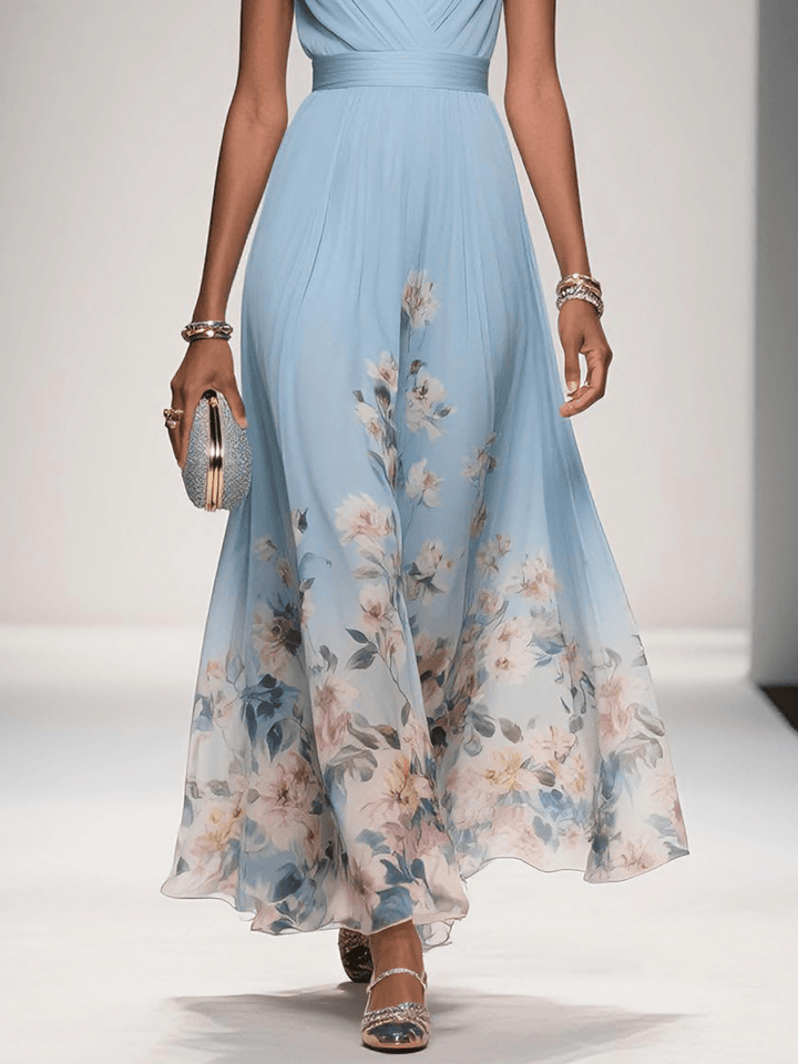 Lower body view of the light blue floral print v-neck sleeveless maxi dress, highlighting the flowing skirt and floral pattern.