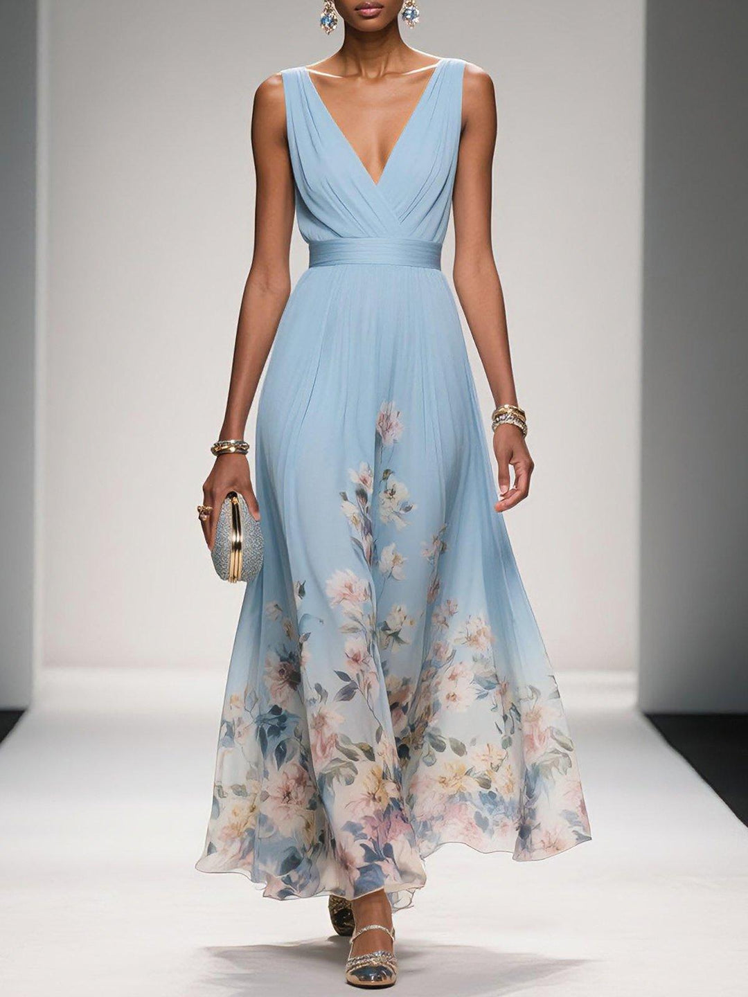 Light blue floral print v-neck sleeveless maxi dress with a pleated bodice and flowing skirt, worn with a silver clutch.