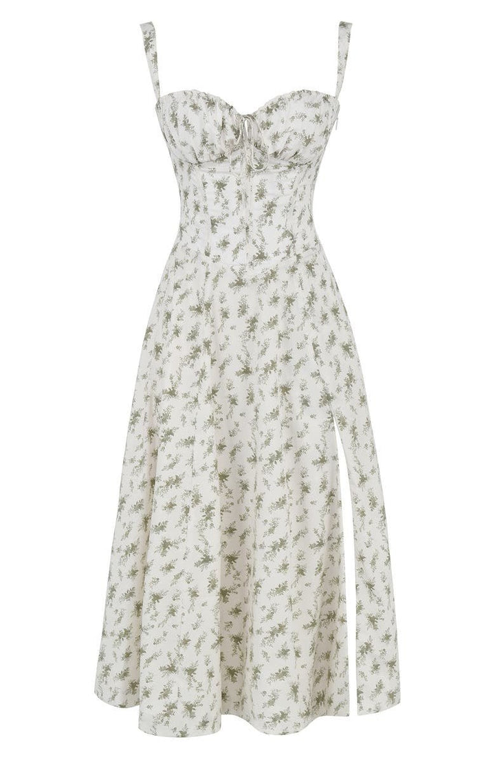 Flat lay of a white floral midi dress with subtle green print, corset bodice, and high side split.