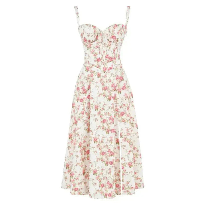 Flat lay of a white floral midi dress with pink rose print, corset design, and a side split.