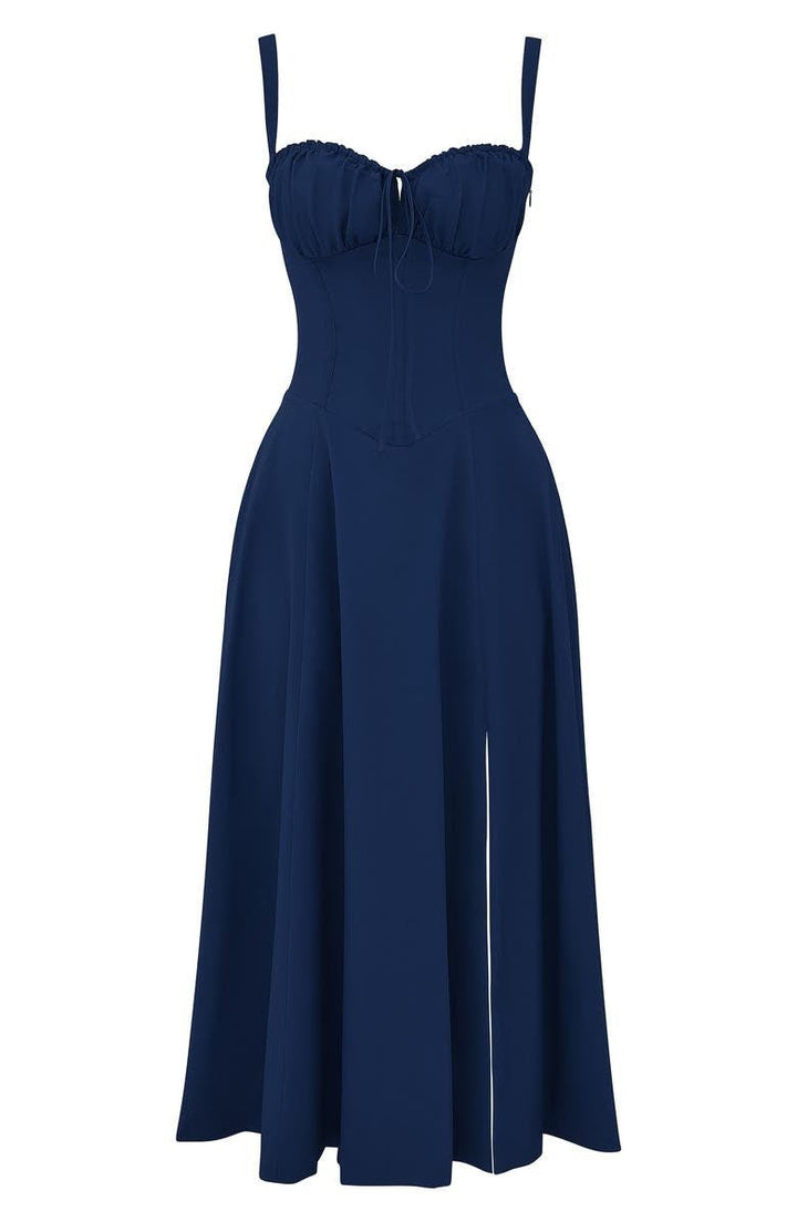 Flat lay of a navy blue midi dress with a structured corset bodice, tie-front, and a side split.