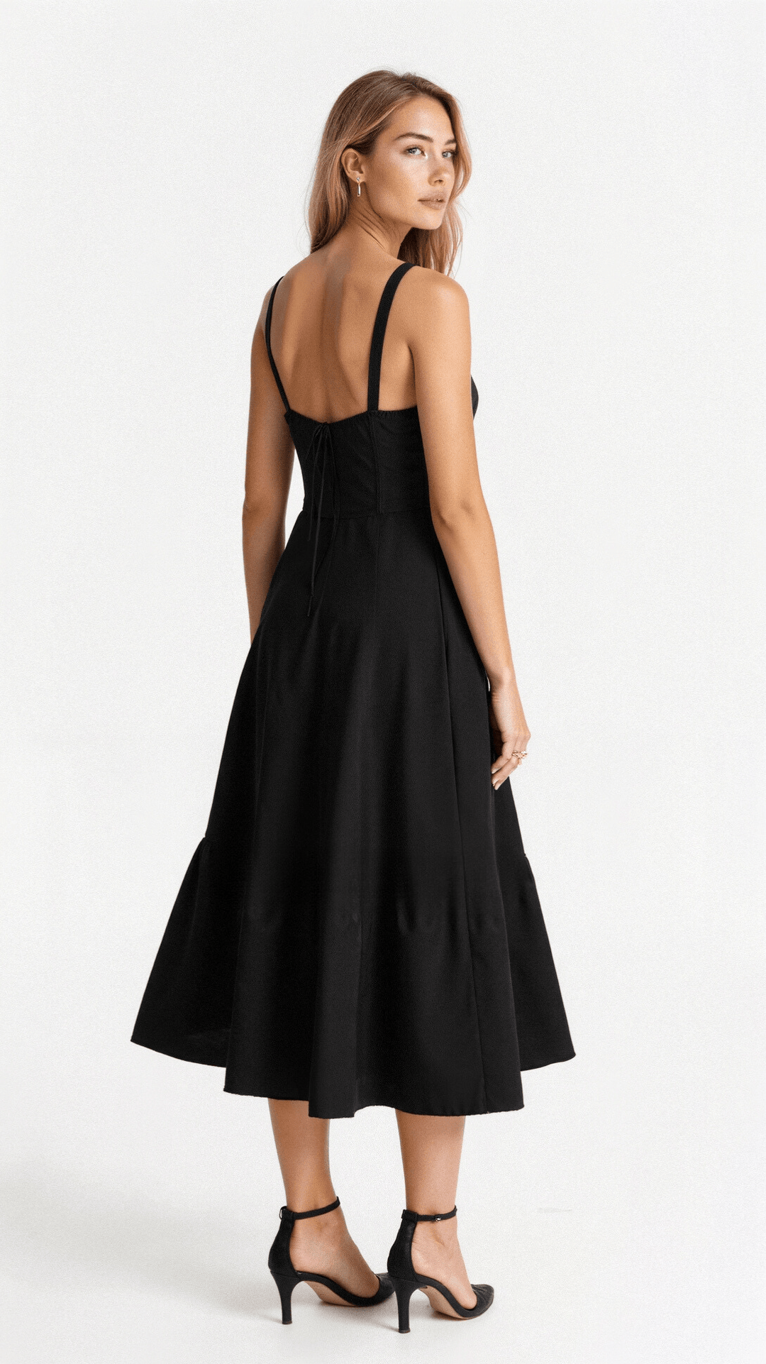 Rear view of a black corset midi dress featuring a lace-up back detail and a full, flowing skirt.