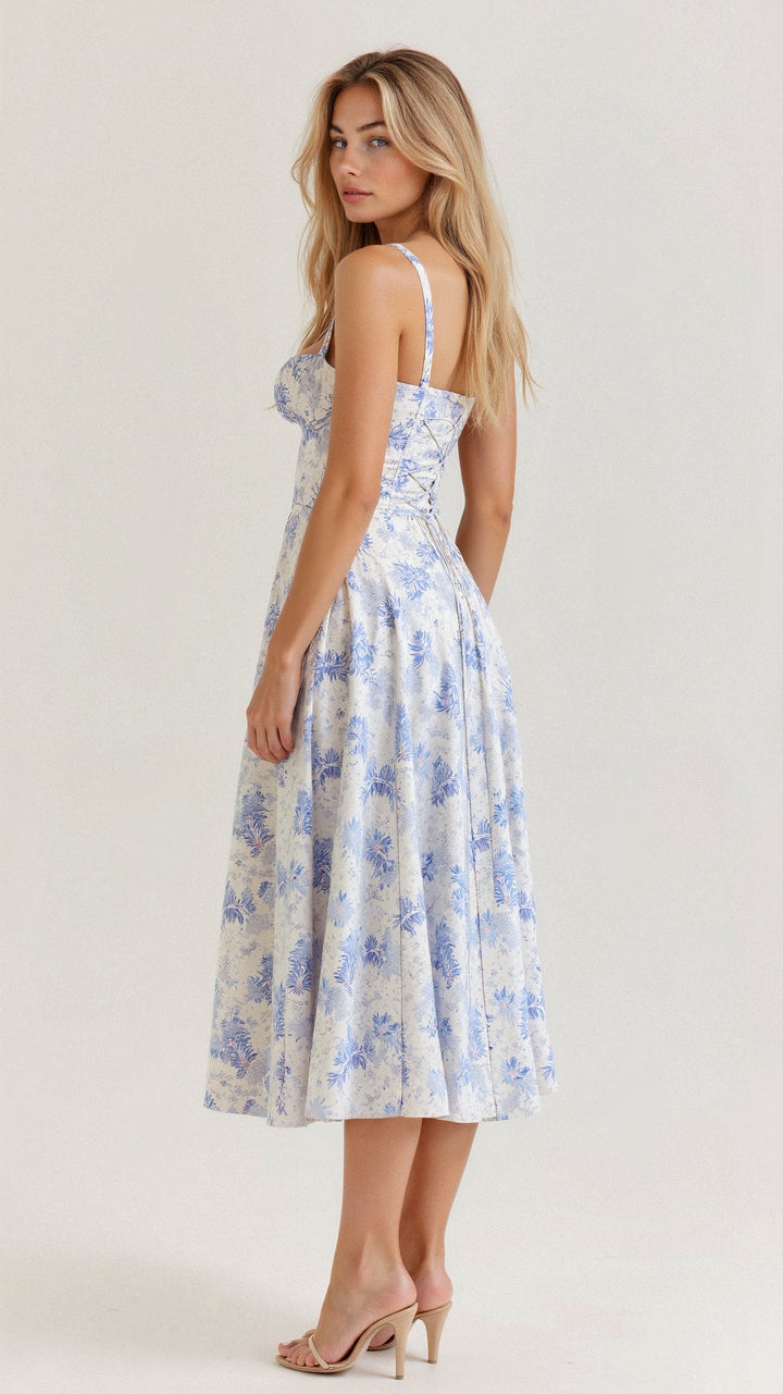 Rear view of white and blue floral midi dress, showcasing the lace-up back and elegant blue flower pattern.
