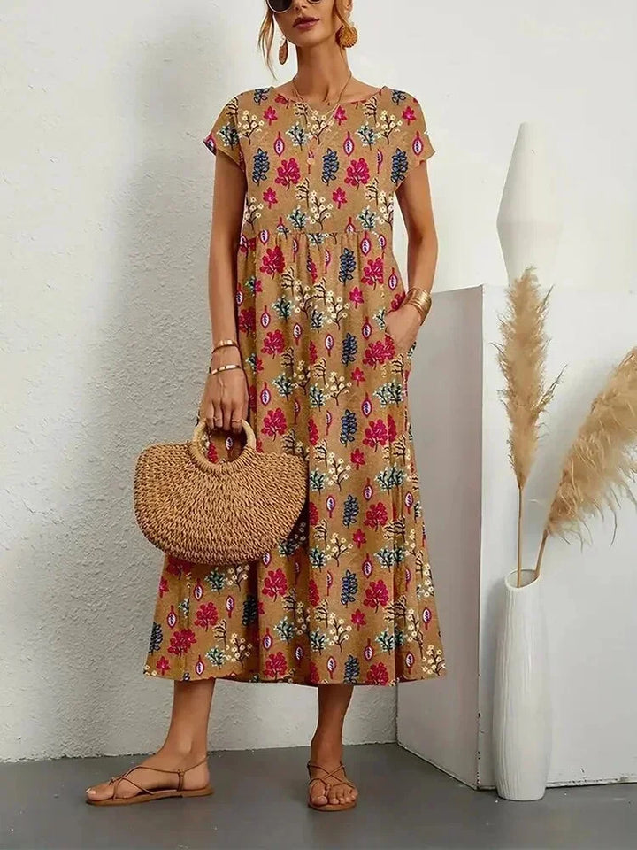Robe midi femme en coton avec imprimé floral, dotée de poches pratiques pour un style décontracté.