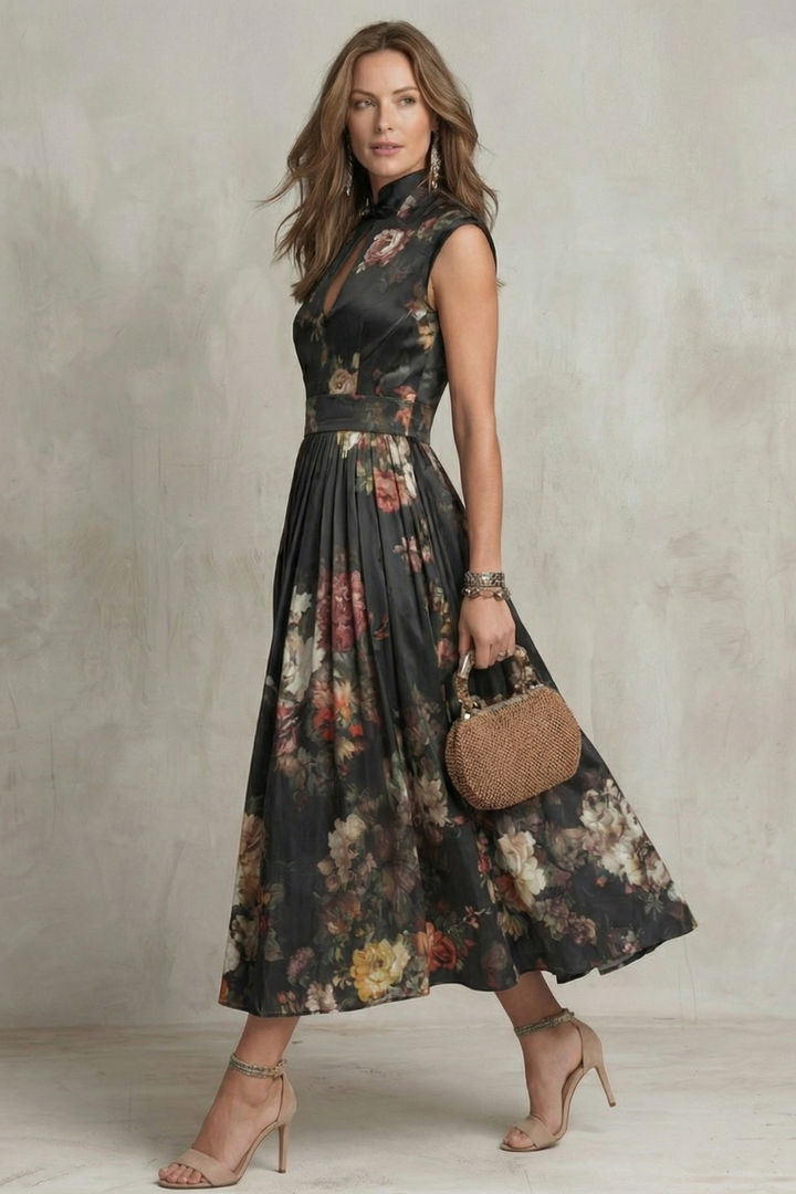 Side view of black floral midi dress showing sleeveless cut and flowing skirt