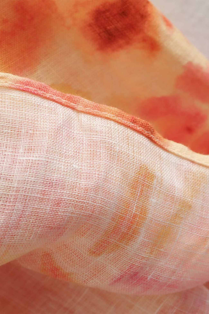 Sheer floral maxi dress fabric with soft orange and pink print, lightweight summer style