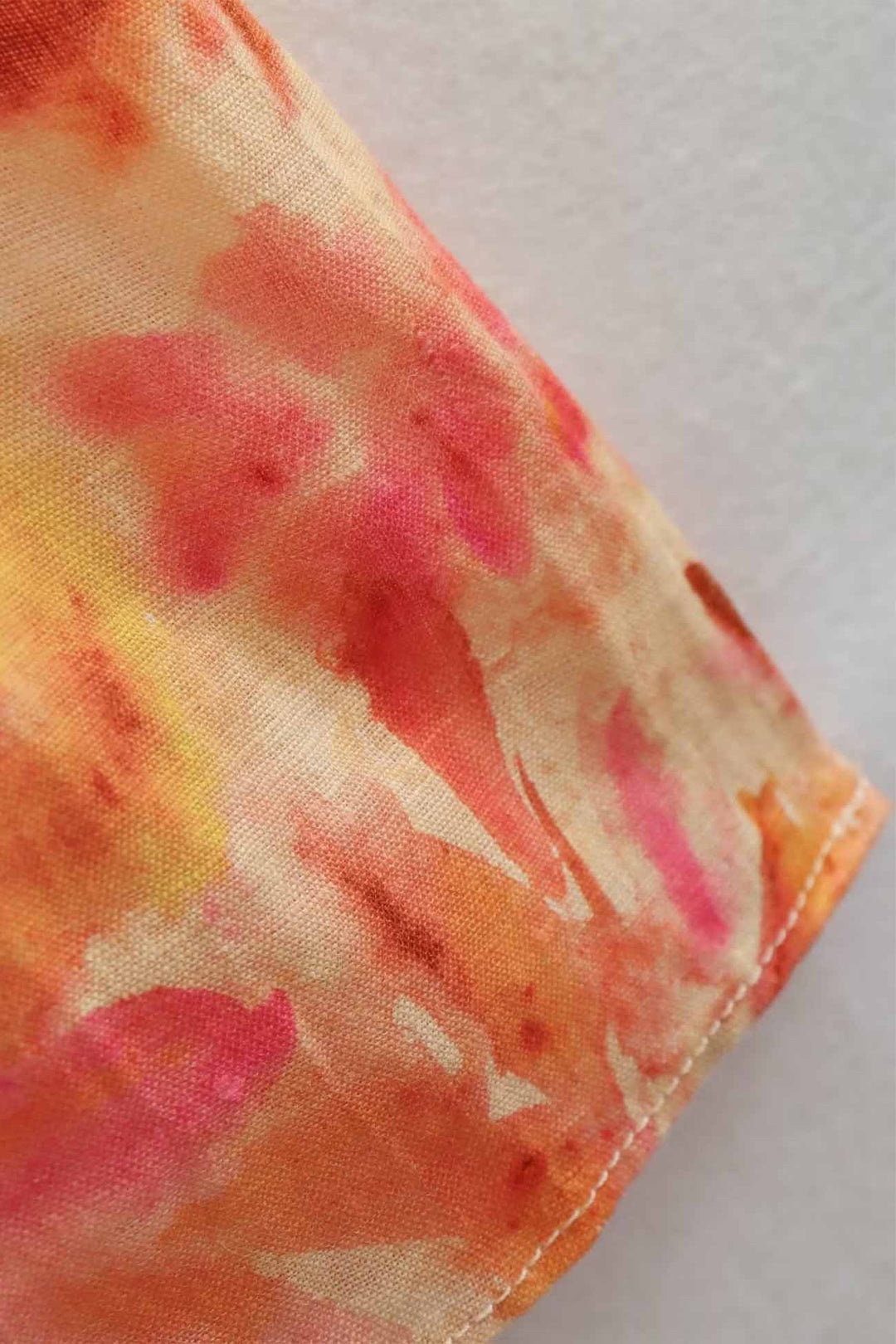 Floral maxi dress sleeve hem in orange, pink and yellow with stitched edge detail