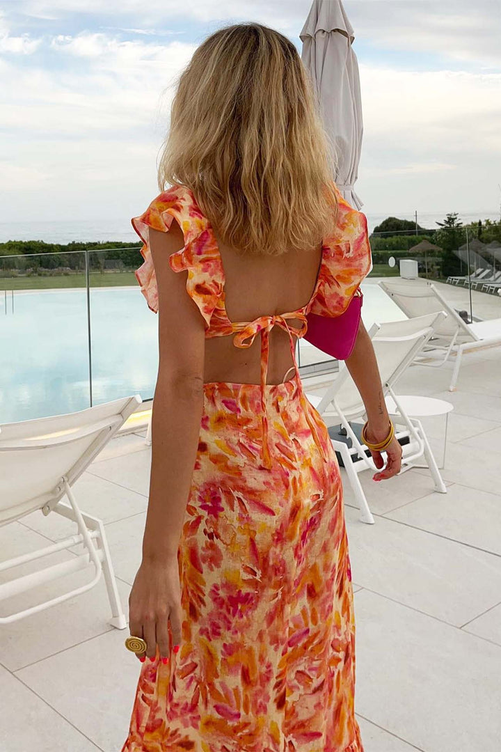 Back view of orange floral V neck maxi dress with open back tie and flutter sleeves