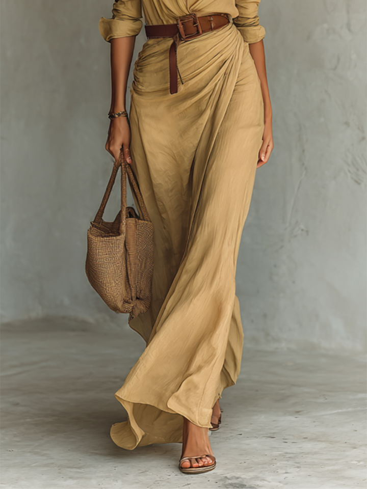 Beige maxi dress detail showing ruched skirt and brown leather belt